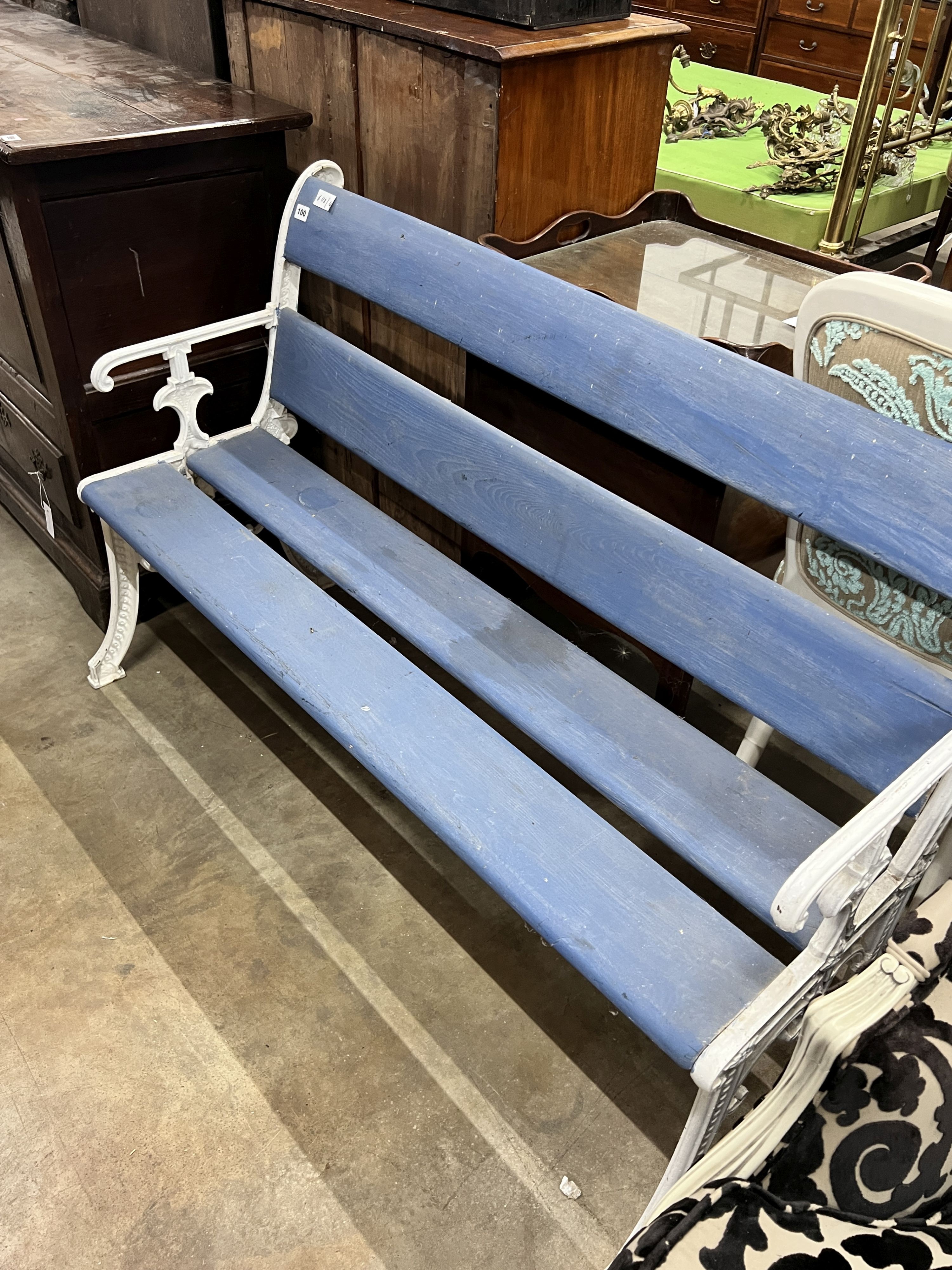 A Victorian style painted cast iron and wooden slatted garden bench, length 131cm, depth 54cm, height 84cm